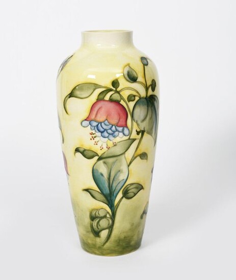 Fuchsia' a Moorcroft Pottery vase designed by Walter Moorcroft, shouldered form with collar rim, tubeline decorated with flower stems in purple, blue and green on a yellow ground impressed factory marks, painted blue signature, 31cm. high