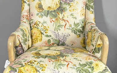 Pair of floral upholstered arm chairs with sabre legs.