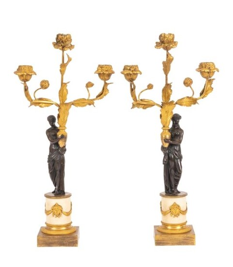 Pair of small Louis XVI style candelabra in chased, patinated...