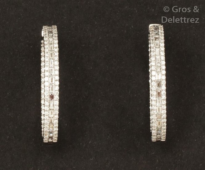 Pair of white gold earrings, each adorned with...