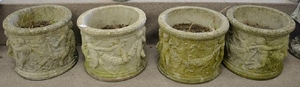 Set of four round cement urns, ht. 12 in., dia. 15 in.