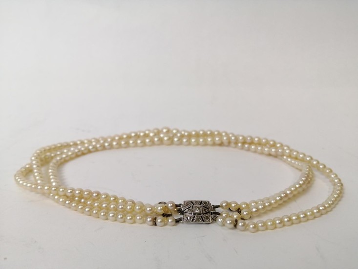 Three strand cultured pearl necklace, on French white gold s...