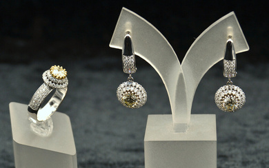 White gold ring and diamond earrings Ring - White gold, 14K, 76 natural diamonds (1 pc - round, brilliant cut, 0.90 ct, 6.22-6.25 mm, SI2; 75 pcs - round, brilliant cut, 0.80 ct, 1.2-1.6 mm, VS-SI). Weight 5.08 g, inner diameter 18.40 mm. Earrings -...