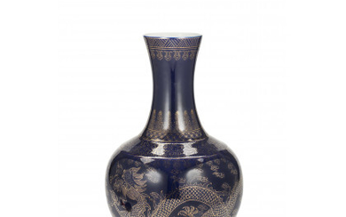 A powder-blue bottle vase with gilt decoration of dragons, with an apocryphal Guangxu seal mark to the base (slight defects)...