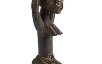 AN AKIE WOODEN FIGURE OF A FEMALE ANCESTOR FROM IVORY...