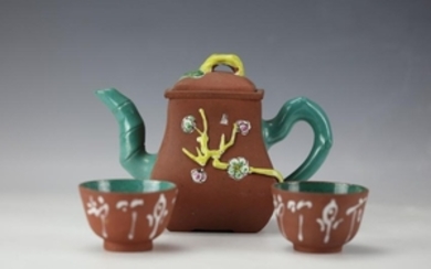 A Turquoise Glazed Clay Teapot with Two Cups