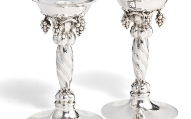 Georg Jensen: A pair of large sterling silver candlesticks with grapes. Spiral fluted stem and hammered surface. H. 20.5 cm. (2)
