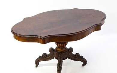 A 19thC mahogany centre table with a moulded top having two ...