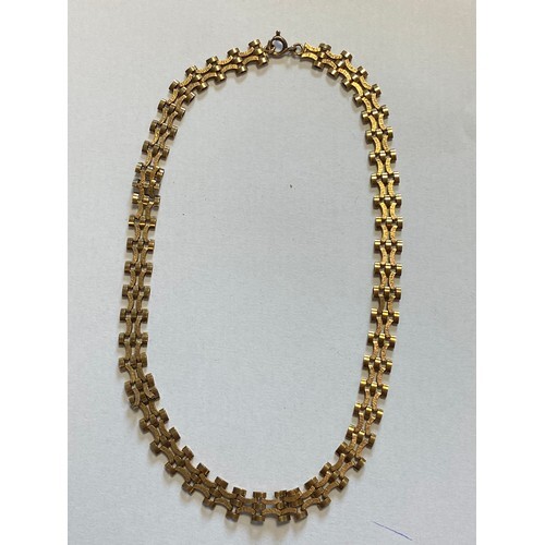 A 9ct gold collar necklace, composed of textured articulated...