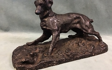 A C19th cast iron figure of a startled spaniel with...