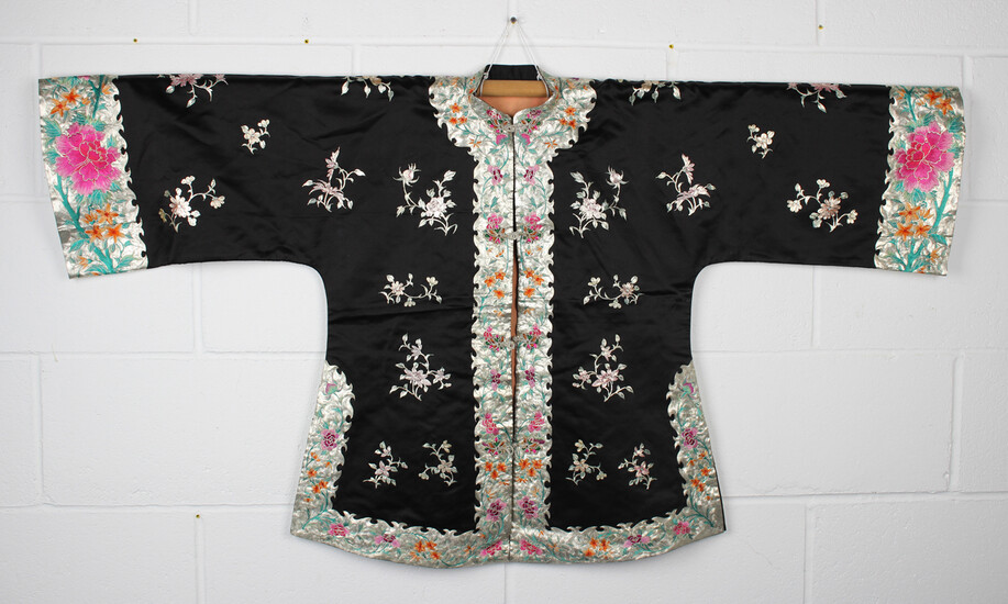 A Chinese black silk embroidered jacket, 20th century, worked in silver/gilt wire thread with flower