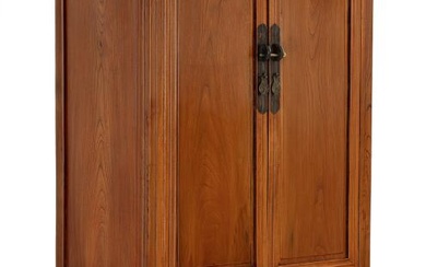 A Chinese polished elmwood cupboard. late 19th century. H. 202 cm. W....