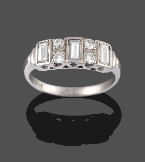A Diamond Ring, three baguette cut diamonds in white rubbed...