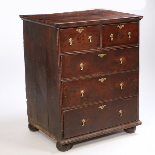 A George III oak chest of drawers, having two short over thr...