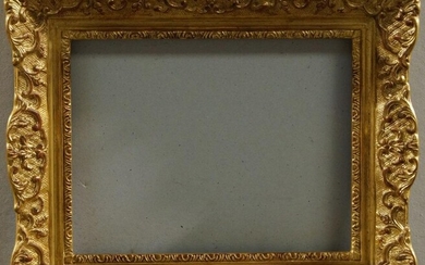 A Gilded Composition Louis XIV Style Frame, late 20th century, of small proportions, with schematic sight, the cross-hatched cushioned hollow with c-scroll and flower head scroll work, foliate cartouche centres and corners, 20 x 26.5 cm (sight): A...