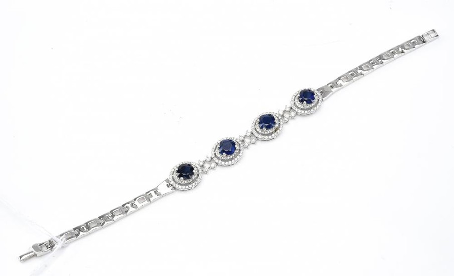 A KYANITE AND DIAMOND BRACELET-Featuring four cushion cut kyanites, each within a double border of round brilliant cut diamonds, wit...