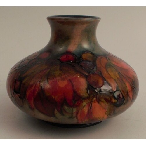 A Moorcroft squat vase, decorated in the Leaf and Berry patt...