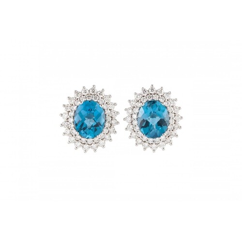 A PAIR OF DIAMOND AND TOPAZ CLUSTER EARRINGS, the oval stone...