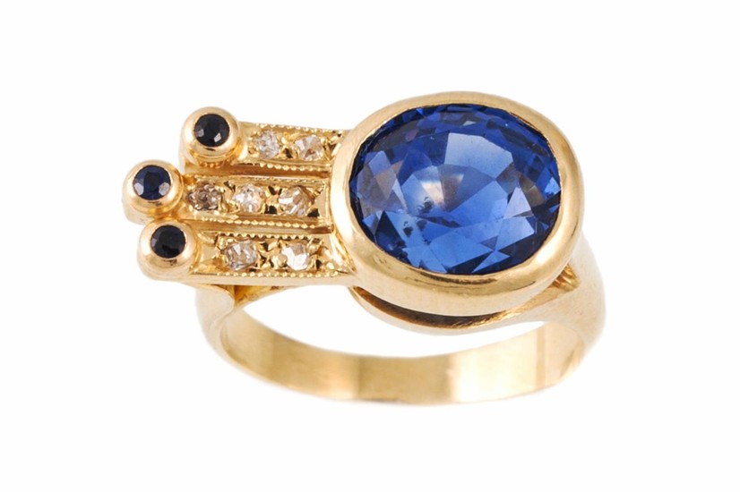 A SAPPHIRE AND DIAMOND RING, the oval cut sapphire estimated...