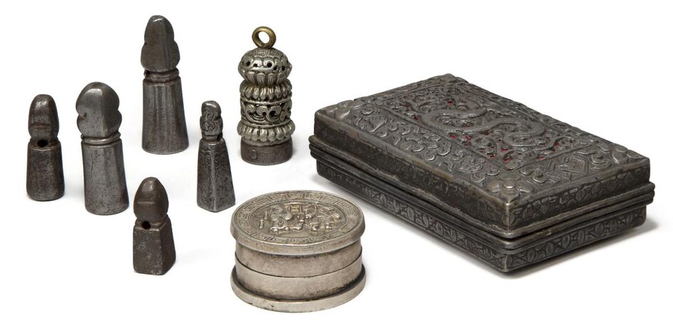A Tibetan white metal repousse box, a seal paste box, and six white metal seals, 19th-early 20th century, the box decorated with a dragon inside a border decorated with auspicious motifs, 10.5cm wide (8)