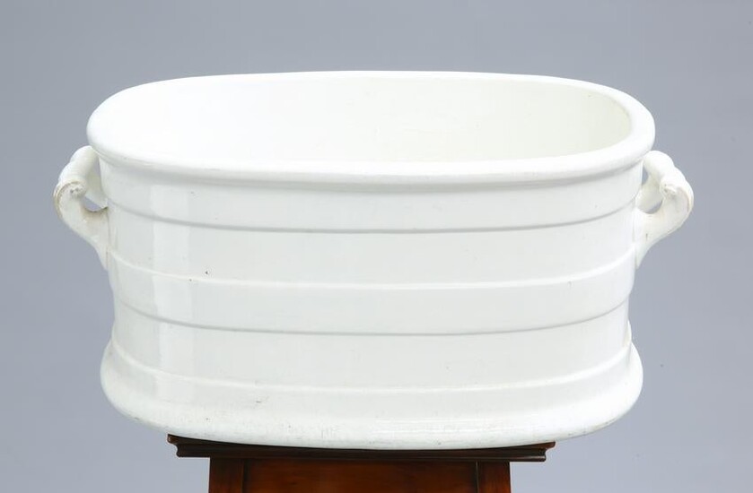 A VICTORIAN WHITE-GLAZED POTTERY FOOTBATH, with twin