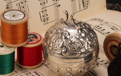 A Victorian silver globular string box, chased with flowers ...