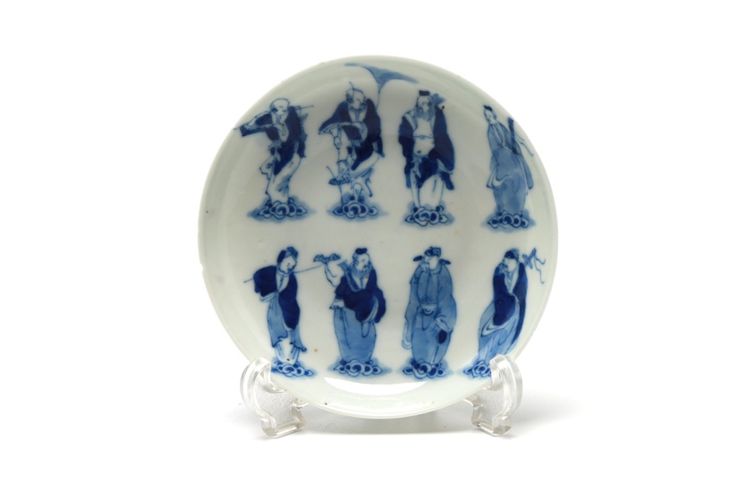 A blue and white porcelain saucer painted with eight immortals