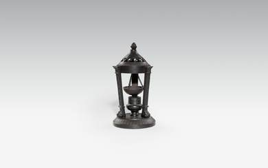 A cast iron incense holder and cover
