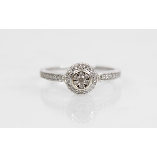 A diamond 18ct gold halo cluster ring, designed as a central...