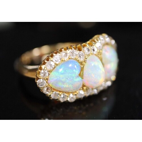 A gold, three stone white opal and diamond set cluster ring,...