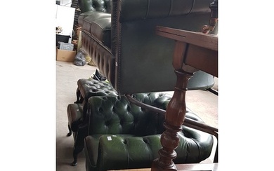 A green leather Chesterfield suite comprising three seater s...