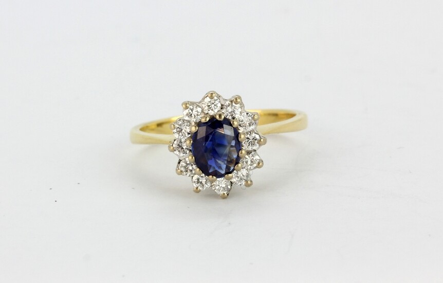 A hallmarked 18ct yellow gold sapphire and diamond set cluster ring, (L).