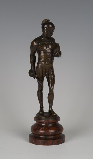 A late 19th century Continental brown patinated cast bronze figure of a Roman soldier holding a shor