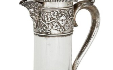 A late Victorian silver mounted glass decanter, London, c.1900, Horace Woodward & Co., the glass body with cylindrical stem and bulbous base to a silver collar decorated with masks and fruiting vines, the lid designed with lion and shield surmount...