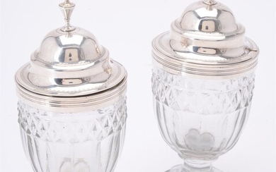 A pair of George III glass mustard jars with silver covers by Charles Chesterman II