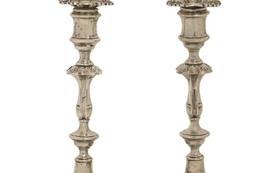 A pair of George V silver candlesticks, in mid 18th c Englis...