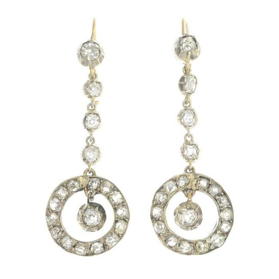 A pair of diamond drop earrings.Estimated total diamond