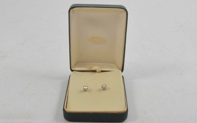 A pair of diamond solitaire earstuds.