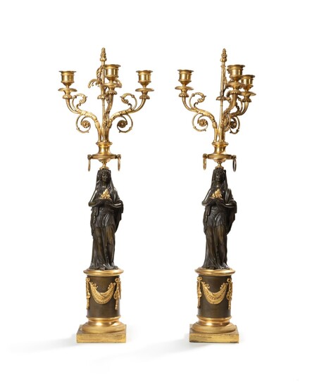 A pair of patinated and gilt bronze candelabra, French Empire, circa 1810 | Paire de candélabres en bronze patiné et doré d'époque Empire, vers 1810
