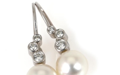 A pair of pearl and diamond ear pendants each set with an...