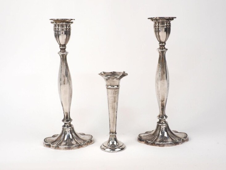 A pair of silver candlesticks, London, 1963, A. Taite & Sons, the panelled stems to scalloped oval feet, 26cm high, together with a silver posy vase, Chester, 1904, maker's mark rubbed, 15.7cm high, weighable weight approx. 15.3oz (3)