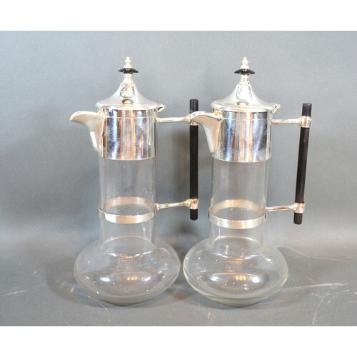 A pair silver plated and glass claret jugs in the style of C...