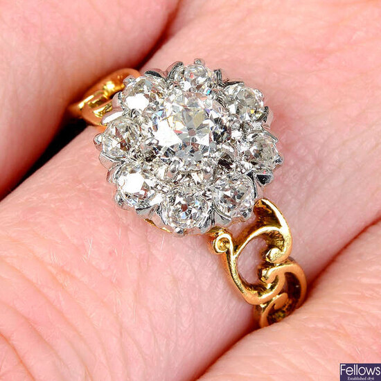 A platinum and 18ct gold old-cut diamond floral cluster ring.