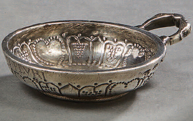 A silver tastevin decorated with hearts, the bottom...