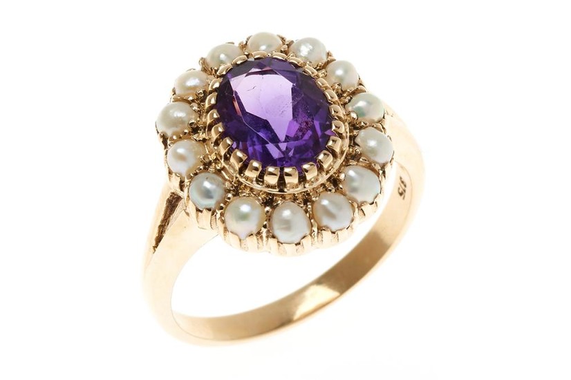 AN AMETHYST AND PEARL CLUSTER RING; centring an oval cut fine deep purple amethyst to surround of seed pearls, in 9ct gold, size N1/2.