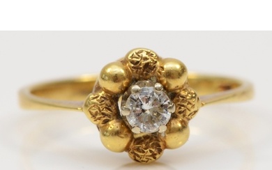 An 18ct gold single stone brilliant cut diamond floral ring,...