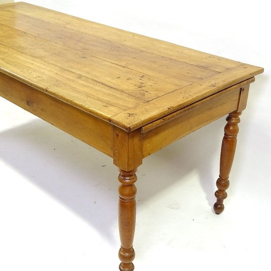 An 18th century French chestnut kitchen table with plank top...