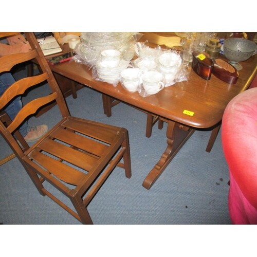 An Ercol elm trestle style dining table and a set of six lad...