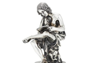 An Italian filled silver coloured figure of a seated youth reading