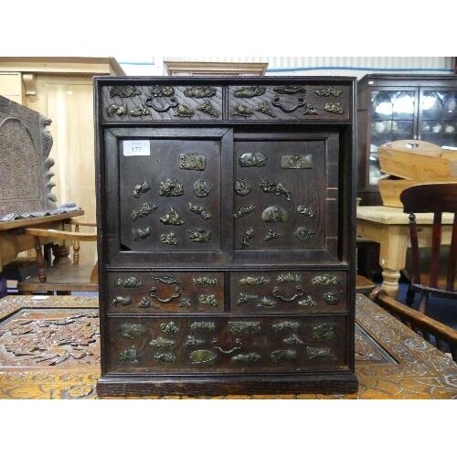 An early 20thC Japanese oak Table Top Cabinet, with a pair o...